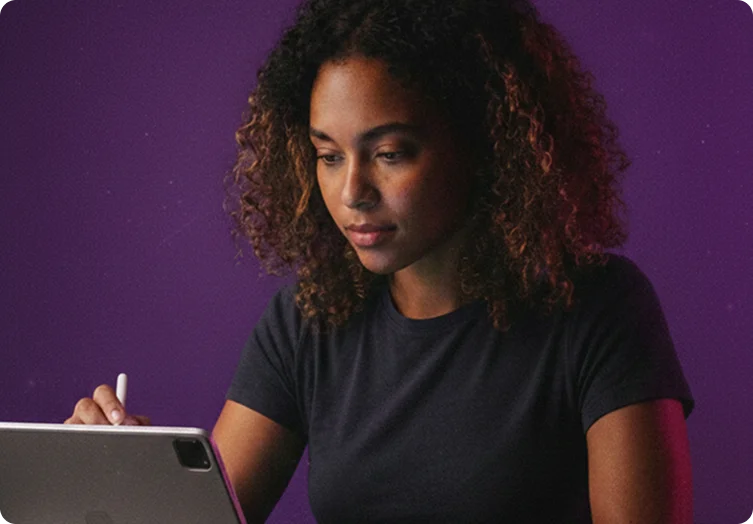 Person using a stylus with a tablet, focused on their work